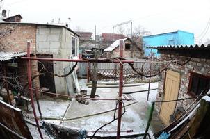 Panoramic shot of the old Ukrainian courtyard with a house and a barn. Artistic fisheye photo with a strong distortion