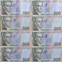 A close-up of a pattern of many Ukrainian currency banknotes with a par value of 500 hryvnia. Background image on business in Ukraine photo