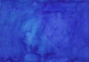 Watercolor deep lapis blue background texture hand painted. Watercolour blue violet stains on paper. photo