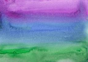 Watercolor deep blue, purple and green ombre background painting texture. Multicolored watercolour liquid backdrop. Stains on paper. photo