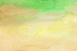 Watercolor bright green and yellow background. Light soft hand painted texture. Stains on paper photo