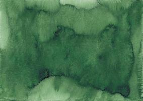 Watercolor dark green background texture. Deep emerald color stains on paper, hand painted. Liquid backdrop photo
