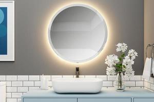 Bathroom with modern wash basin and round mirror, light blue cabinet and flower vase, gray wall and white tile wall. 3d rendering photo