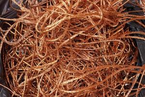 Bag of electrical copper waste, scrap copper wire material for recycling business - expensive metal. photo