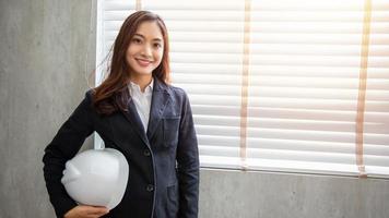 Professional Asian female engineer Standing confidently smiling in the office photo