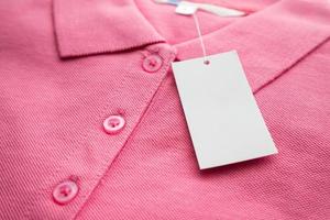 Blank white clothes tag label on new shirt photo