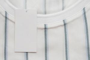 Blank white clothes tag label on new shirt photo