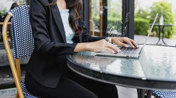 Businesswoman working  laptop and sign of the top service Quality assurance, Guarantee, Standards, ISO certification and standardization, concept Quality assurance of business services. photo