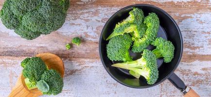 brócoli fresco para cocinar en una mesa de madera,verduras saludables.vista superior foto