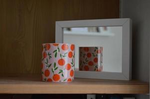 Patterned Candle Holder Reflected in a Mirror photo