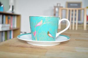 Pretty Blue Teacup on a Wooden Table photo