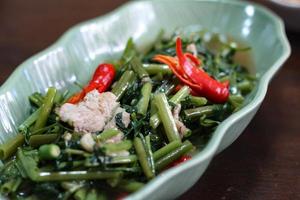 Stir-fried morning glory in a black dish Stir Fried Morning Glory is also one of the most delicious dishes you can eat in Thailand. photo