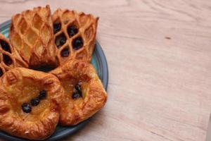 Lattice Jam Tart served in a plate on a wooden table. photo