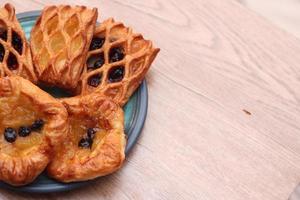 Lattice Jam Tart served in a plate on a wooden table. photo