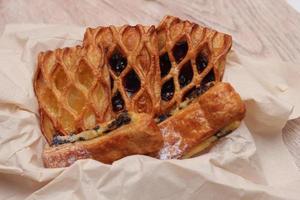 Lattice Jam Tart served in a plate on a wooden table. photo