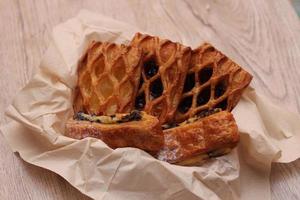 Lattice Jam Tart served in a plate on a wooden table. photo