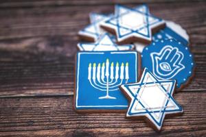 Delicious festive Hanukkah cookies for celebrating on a wooden background. Closeup photo