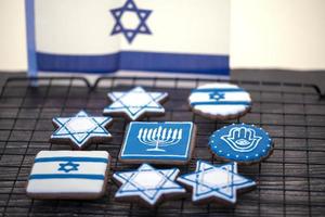 Delicious festive Hanukkah cookies for celebrating on a wooden background. Closeup photo