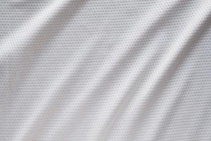 White fabric sport clothing football jersey with air mesh texture background photo