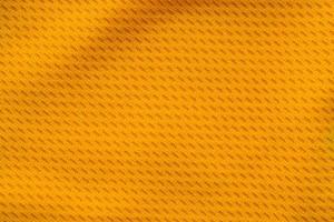 Orange color sports clothing fabric jersey football shirt texture top view photo