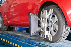 Car wheel alignment in progress at auto repair service centre photo