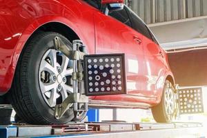 Car wheel alignment in progress at auto repair service centre photo