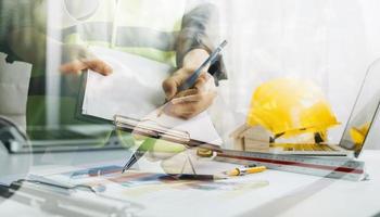 Scene of industrial engineers discussion, Construction architect with huge industry as a background, Concept of engineer project planning, professional teamwork. Selective focused. photo