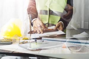 Scene of industrial engineers discussion, Construction architect with huge industry as a background, Concept of engineer project planning, professional teamwork. Selective focused. photo