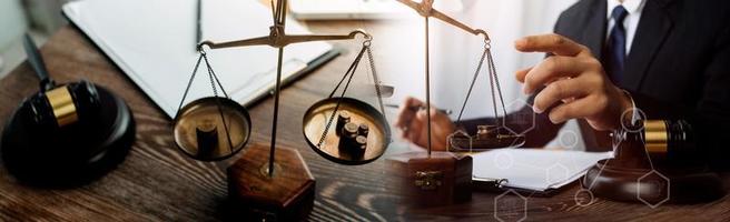 Male lawyer working with contract papers and wooden gavel on tabel in courtroom. justice and law ,attorney, court judge, concept. photo