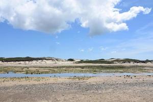 Blue Skies and Fluffy Clouds Over Sand Dunes and Tidal Marsh photo