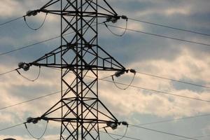 Electric towers supporting the copper cables that transmit and transport electricity photo