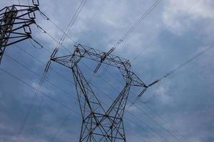 Electric towers supporting the copper cables that transmit and transport electricity photo