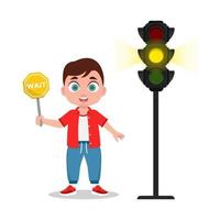 Schoolboy with a waiting sign. The traffic light shows a yellow signal