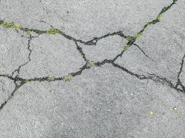 Detailed view on asphalt surfaces of different streets and roads with cracks photo