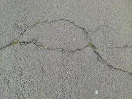 Detailed view on asphalt surfaces of different streets and roads with cracks photo