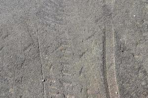 Detailed view on asphalt surfaces of different streets and roads with cracks photo