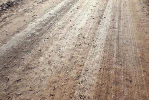 Detailed close up view on a brown sand ground texture photo