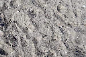 Detailed close up view on a brown sand ground texture photo