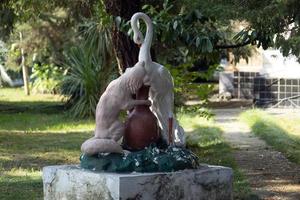 Sukhumi, Abkhazia - August 5, 2017- Sculpture of a fox and a heron in the park of the Sukhumi military sanatorium photo