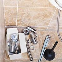 repairing of rusted sink siphon in bathroom photo