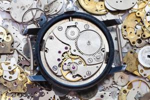 used mechanical wristwatch on heap of spare parts photo