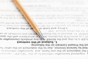 golden pen on page of sales agreement photo