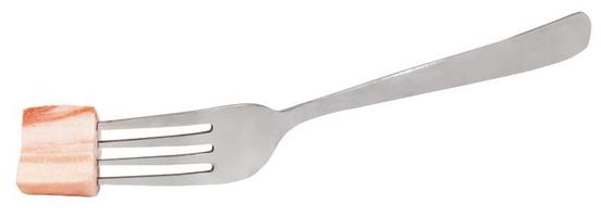 fork with impaled piece of salty lard isolated photo