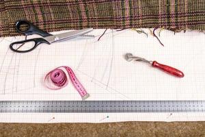cutting table with cloth, pattern, tailoring tools photo