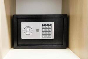 compact safe on shelf of cabinet photo