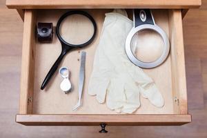 magnifier, forceps and gloves in open drawer photo