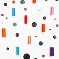 spools of sewing thread and different buttons photo