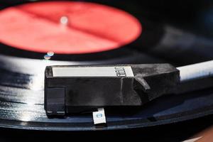 tonearm on vinyl record in old turntable photo