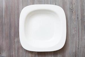 above view of white bowl on gray brown table photo