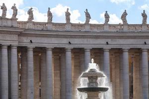 fountain and colonnade on piazza San Pietro photo